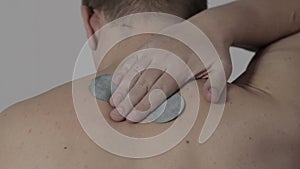 A man glues a medical plaster to the cervical spine, close-up