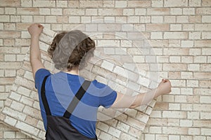 A man glues Wallpaper at home. Repair with your own hands