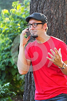 Man with goatee talking on phone