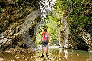 The man goes in a canyon in the jungle.