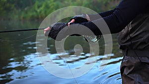 Man goes fly fishing in the morning river