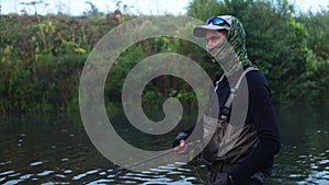 Man goes fly fishing in the morning river