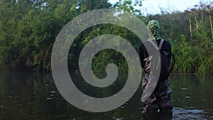 Man goes fly fishing in the morning river