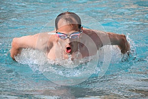 Man in goggles swimming jumped out of water photo