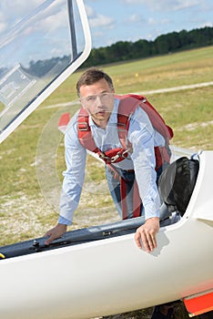 Man going inside glider aircraft