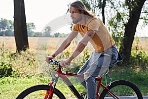 Man going of the road by bicycle