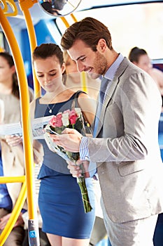 Man Going To Date On Bus Holding Bunch Of Flowers