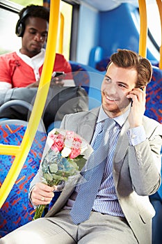 Man Going To Date On Bus Holding Bunch Of Flowers