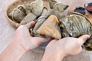A man is going to eat zongzi or rice dumpling on Dragon Boat Festival
