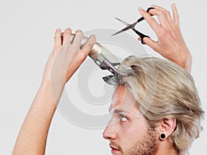 Man going to shave his long hair