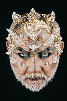 Man with golden reptilian skin and white beard. Monster with sharp thorns and warts on face, horror and fantasy concept
