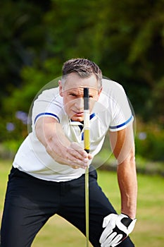 Man, golf and club with grass for aim for putt with strategy for skill in sportswear on course. Male person, health and