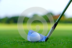 Man Golfer Hitting Ball with Club on Beatuiful Golf Course