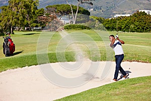 Man, golfer and swing with stroke in sand pit for par, bogey or strike with grass field in nature. Young male person or