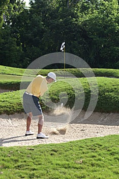 Man Golfing from Sand Bunker