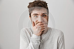 Man got insane. Portrait of weird crazy guy with messy haircut laughing and looking with strange expression at camera