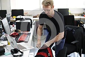 Man Grabbing Backpack Leaving After Work Hour