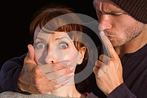 Man grabbing woman around mouth