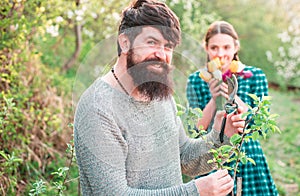 Man grafting spring branch. Smiling man preparing to planting. Graft.