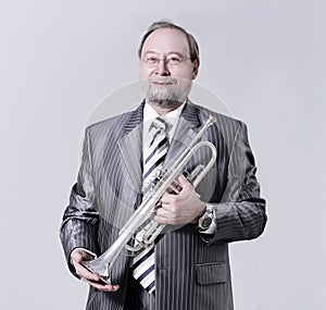 Man in a gray suit with a trumpet