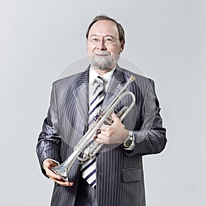 Man in a gray suit with a trumpet