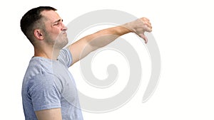 A man in a gray T-shirt, on a white background, close-up, shows his thumbs down