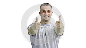 A man in a gray T-shirt, on a white background, close-up, shows his thumbs up