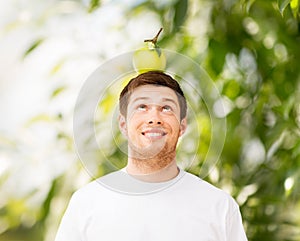 Man with green apple on his head