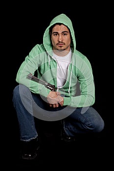 Man green hoodie gun on black