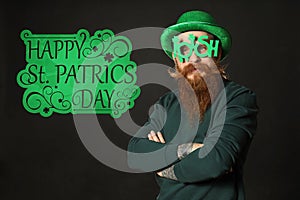 Man in green leprechaun hat with party glasses on background St. Patrick`s Day celebration