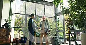 Man, greeting and handshake for welcome to hotel on travel business, assistance and luggage or suitcase for courtesy or