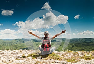 Man greeting nature on the top of mountain