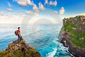 Man greeting nature on the top of mountain