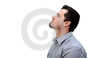 Man in Grey Shirt looking up on white backdrop Copyspace