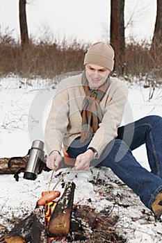 Man grilled sausages