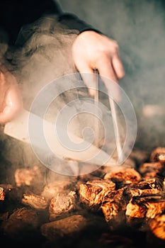 Man grilling food on a barbecue in a backyard setting