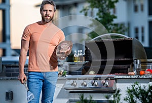 man grilling his favorite meats, copy space. Grill virtuoso flavor. cook showcasing his barbecue techniques at cookout