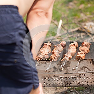 Man grilling shish kebab