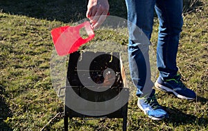 A man grills a barbecue on a grill at a picnic.