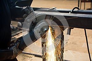 Man grinding metal with angle grinder