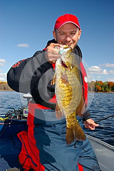 Man Fishing Holding Smallmouth Bass photo