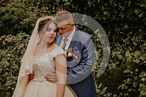 man groom woman bride newlyweds guy hugs a girl from behind