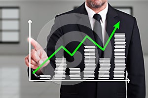 Man with growth chart business diagram on digital screen