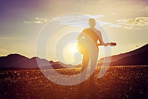 Man guitar sunset mountains concept