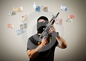 Man with gun and euro banknotes.