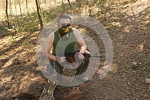 A man with a gun in a forest