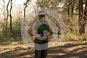 A man with a gun in a forest