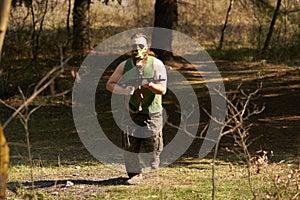 A man with a gun in a forest