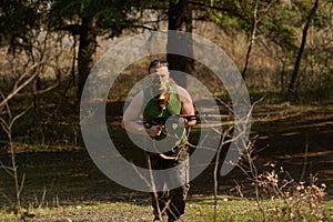 A man with a gun in a forest