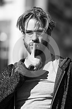 Man or guy with finger on lips gesture